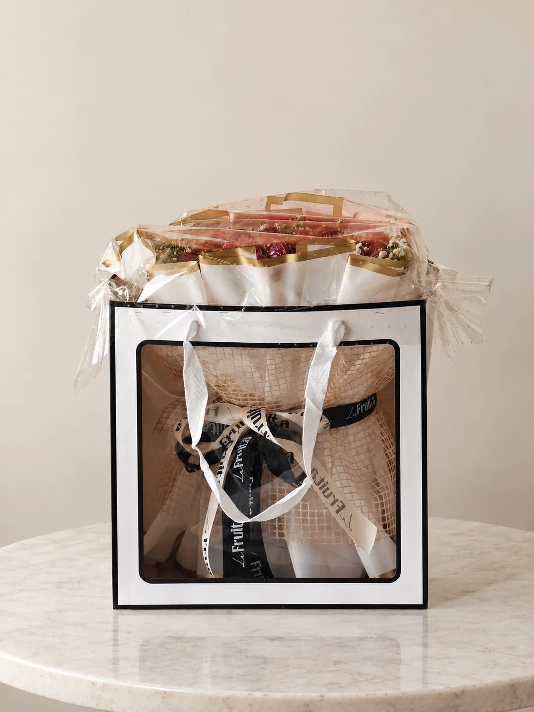 A La Fruita fruit bouquet wrapped and secured in its carry bag