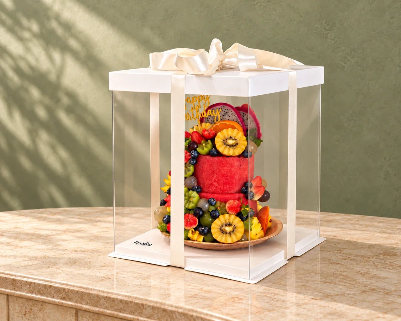 All-fruit cake in a clear presentation box with an ivory ribbon